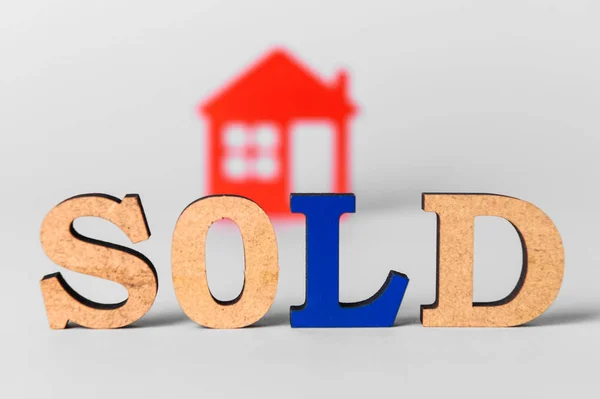 Word SOLD with figure of house on white background. Concept of buying real estate — 스톡 사진