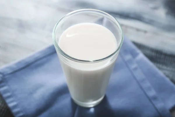 Glass of tasty milk on wooden table — Stock Photo, Image
