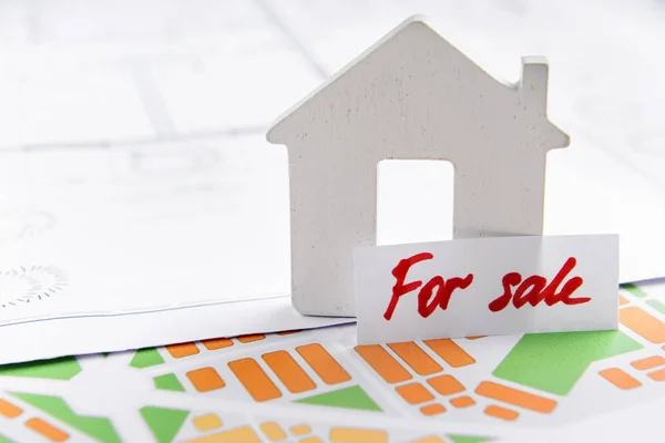 Figure of house with plan on city map. Concept of buying real estate — Stock Photo, Image