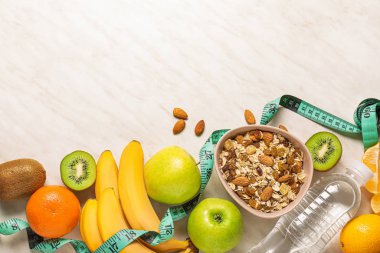 Different healthy food with measuring tape on light background. Diet concept