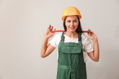 Female worker on light background. Concept of feminism