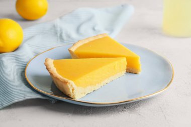 Plate with slices of tasty homemade lemon pie on table