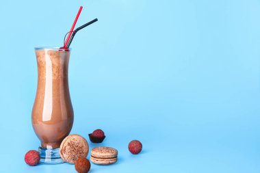 Glass of tasty milkshake on color background