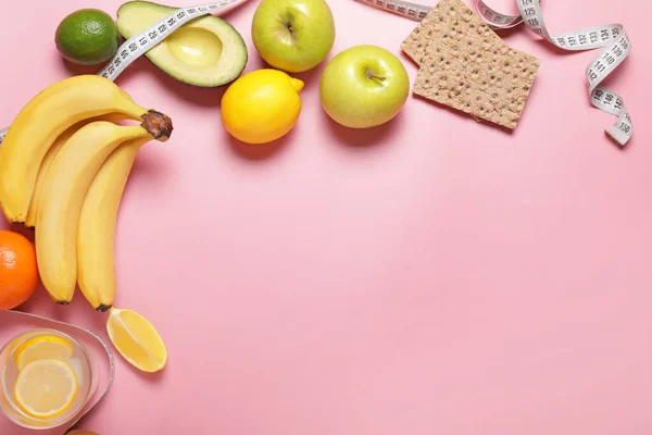 Different healthy food with measuring tape on color background. Diet concept — Stok fotoğraf