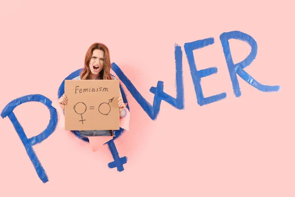 Fiatal nő néz ki a lyukból színes papír szó Power. A feminizmus fogalma — Stock Fotó