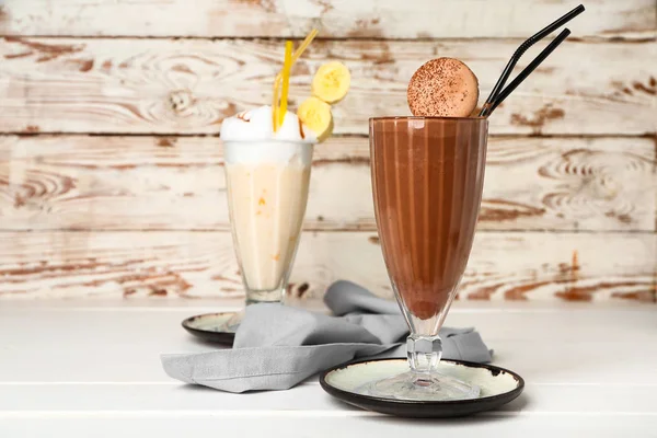 Glasses of tasty milkshakes on table — Stock Photo, Image