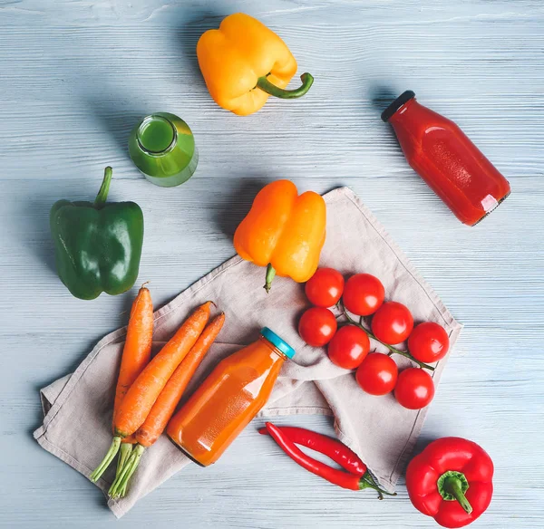 Bottles of fresh vegetable juices on wooden table — Stock Photo, Image