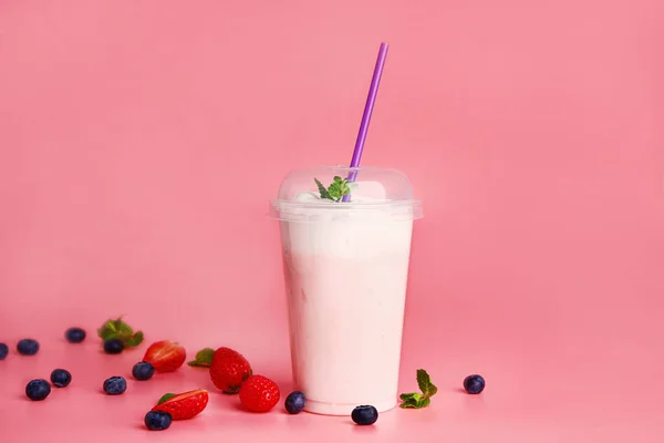 Cup of tasty milkshake on color background — Stock Photo, Image