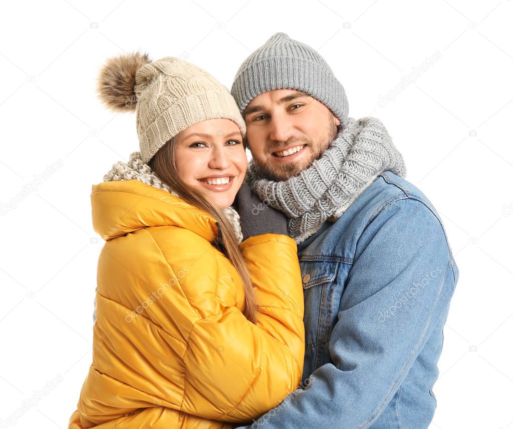 Portrait of happy couple in winter clothes on white background