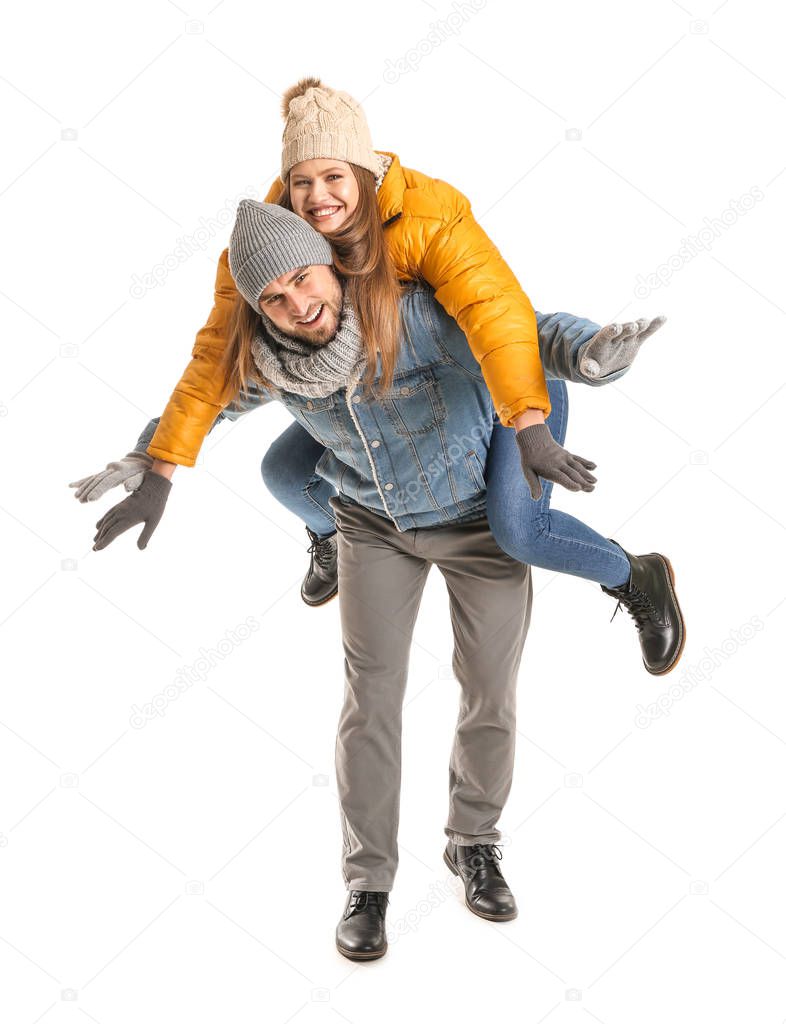 Portrait of happy couple in winter clothes on white background