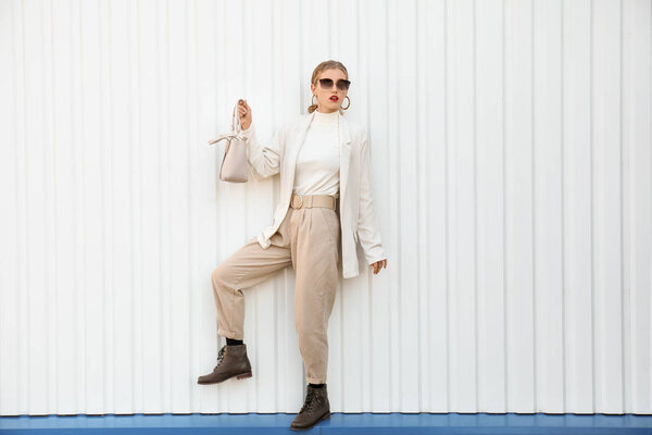 Portrait of fashionable young woman on white background