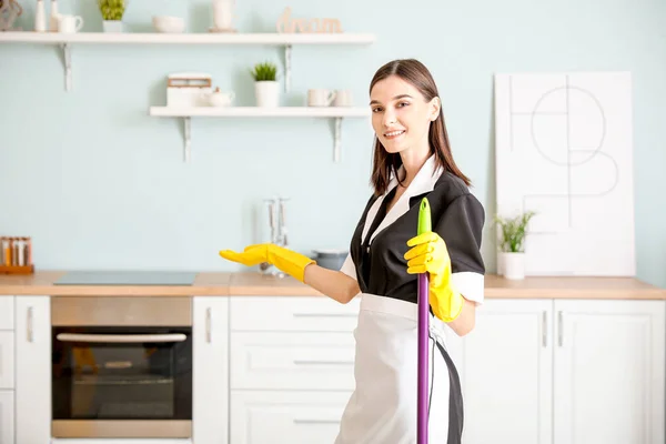 Portrait of beautiful young chambermaid in kitchen — 스톡 사진