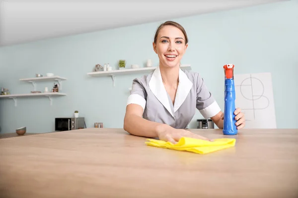 Beautiful young chambermaid cleaning kitchen — 스톡 사진