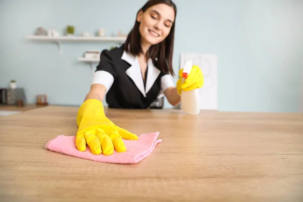 Beautiful young chambermaid cleaning kitchen — 스톡 사진