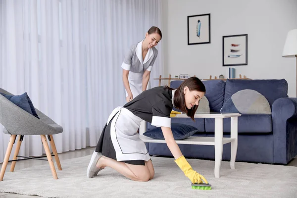 Beautiful young chambermaids cleaning hotel room — 스톡 사진