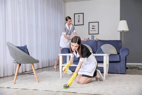 Mooie jonge kamermeisjes schoonmaken hotelkamer — Stockfoto