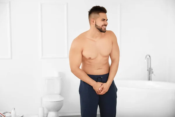 Young man with urologic disease in bathroom — Stock Photo, Image