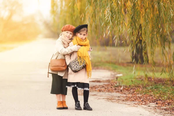 Cute little girls in autumn clothes outdoors — Stock Photo, Image