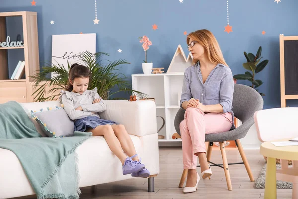 Psychologist working with sad little girl indoors — Stock Photo, Image