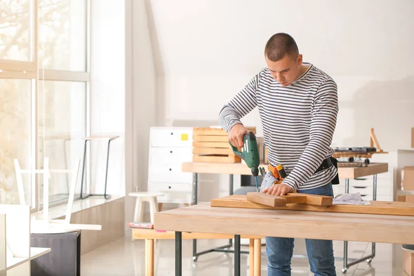 Handyman assembling furniture in workshop — Stock Photo, Image