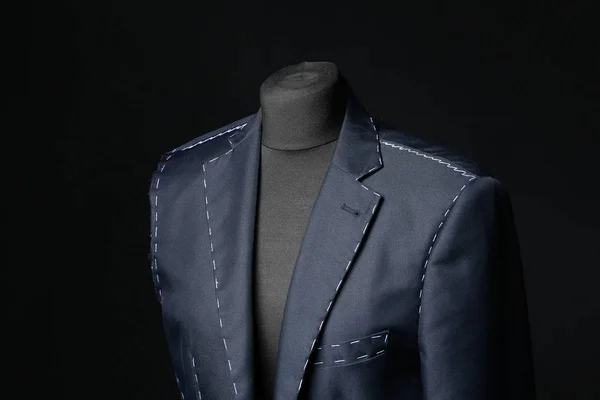 Mannequin with half-finished jacket on dark background — 스톡 사진