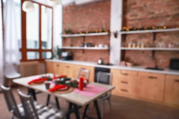 Served table for Christmas dinner in interior of stylish kitchen, blurred view — Stock Photo, Image