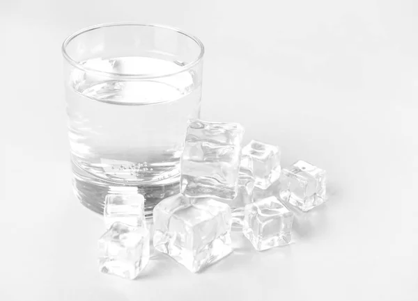 Glass of clean water and ice cubes on light background — 스톡 사진