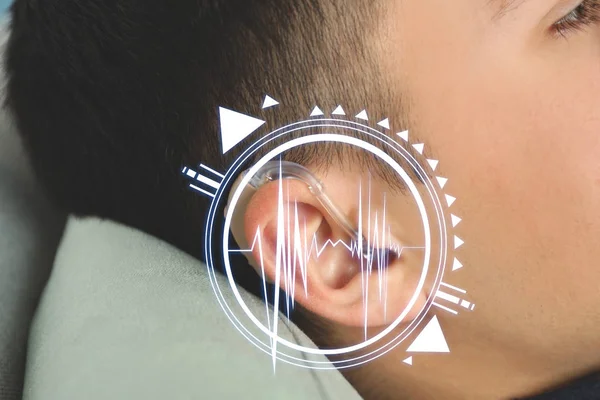 Young man with hearing aid at home, closeup — Stock Photo, Image