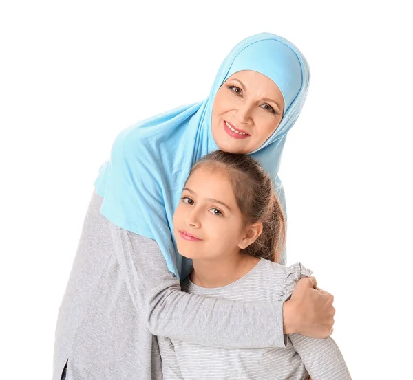 Portrait of Muslim woman with granddaughter on white background — Stock Photo, Image