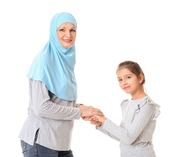 Portrait of Muslim woman with granddaughter on white background — Stock Photo, Image