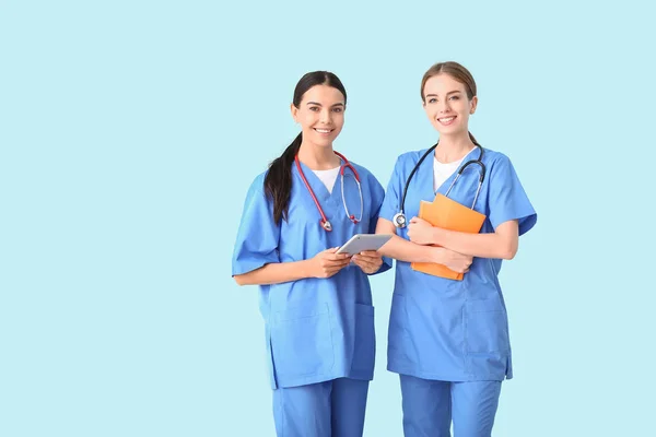 Female medical students on color background — Stock Photo, Image