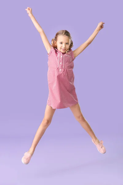 Jumping little girl on color background — Stock Photo, Image