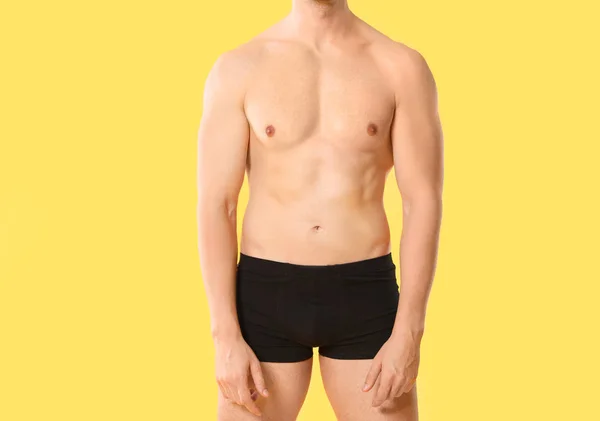 Handsome man in underwear on color background — 스톡 사진