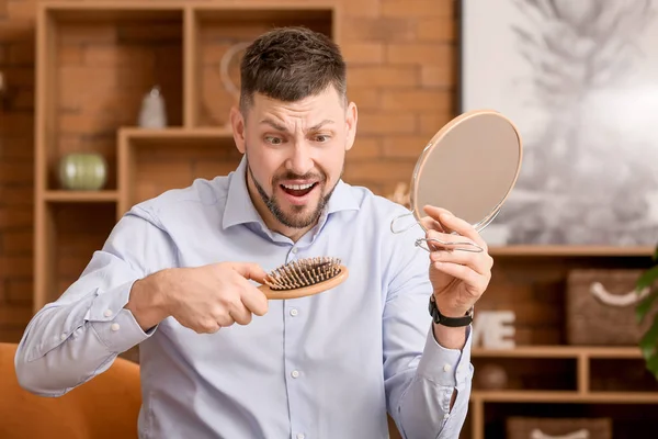 Worried man with hair loss problem at home — Stock Photo, Image