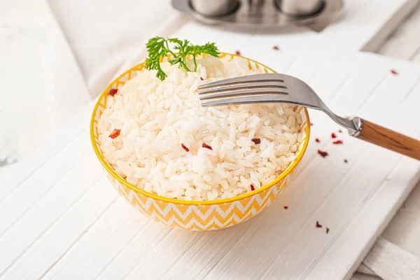 Bowl with boiled rice and spices on table — Stock Photo, Image