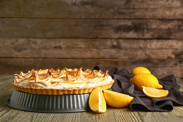 Tasty lemon pie on wooden table