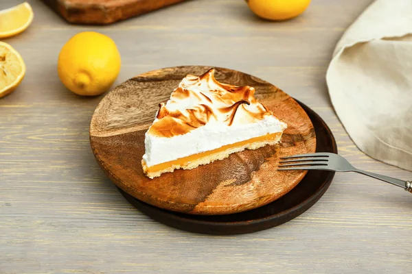 Plate with piece of tasty lemon pie on table — Stock Photo, Image