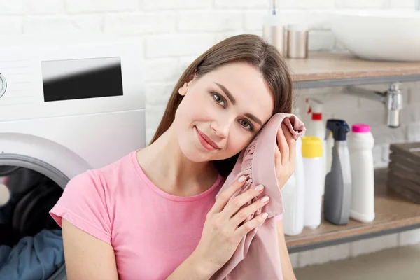 Young housewife washing laundry at home — 스톡 사진