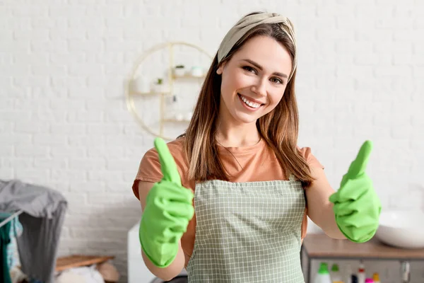 Young housewife showing thumb-up at home — Stock Photo, Image