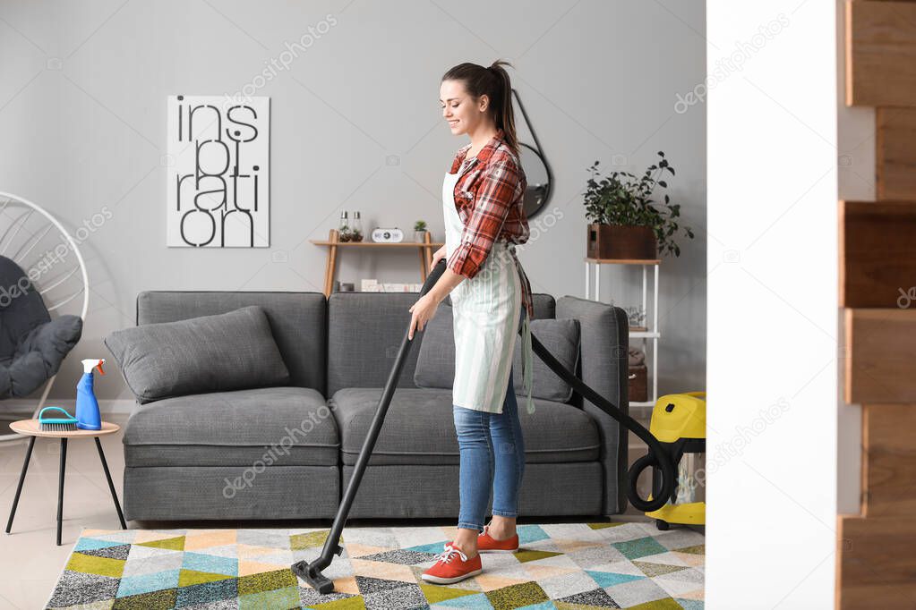 Young housewife cleaning her flat