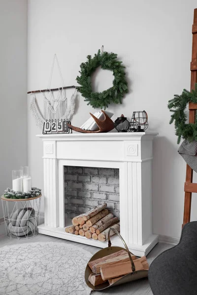 Fireplace with Christmas decor in stylish living room — Stock Photo, Image