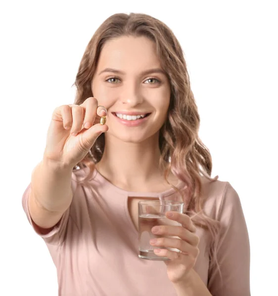 Young woman with fish oil on white background — Stock Photo, Image