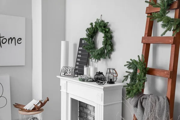 Fireplace with Christmas decor in stylish living room — Stock Photo, Image