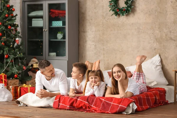 Happy family resting on Christmas eve at home — Stock Photo, Image
