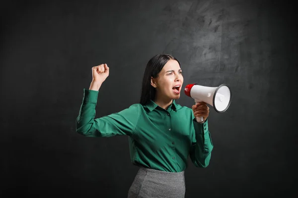 Female teacher with megaphone near blackboard in classroom — Stock Photo, Image