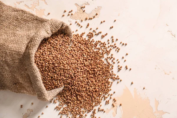 Bag with raw buckwheat on table — Stock Photo, Image