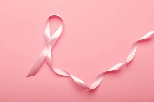 Pink ribbon on color background. Breast cancer awareness concept — Stock Photo, Image