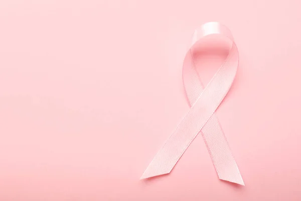 Pink ribbon on color background. Breast cancer awareness concept — Stock Photo, Image