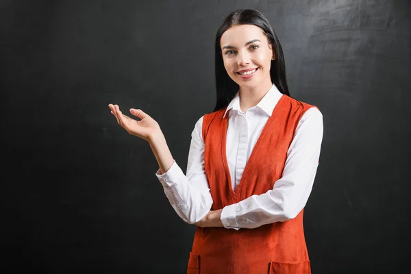 Female teacher near blackboard in classroom — Stock Photo, Image