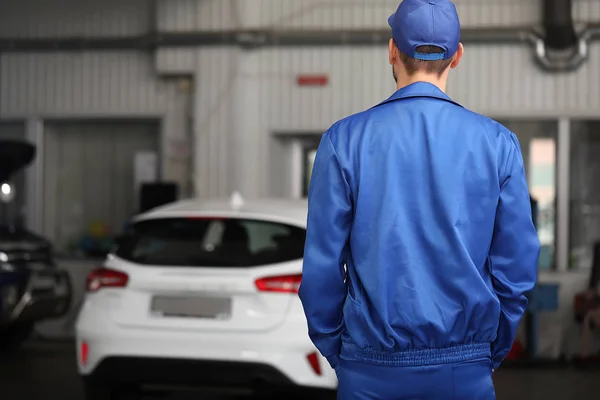 Mecânico masculino no centro de serviço de carro, visão traseira — Fotografia de Stock